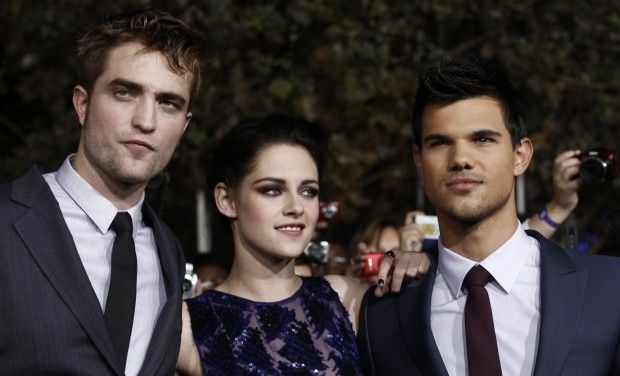 Robert Pattinson, Left, Kristen Stewart, and Taylor Launter, right, arrive at the world premiere of "The Twilight Saga: Breaking Dawn - Part 1" on Monday, Nov. 14, 2011, in Los Angeles.