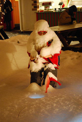 Santa fishing in the snow.