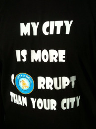 One Bell resident expressed his outrage over exorbitant pay for city officials on his T-shirt at a recent community meeting.