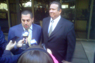 Defense Attorney George Mgdesyan and his client, former Bell city councilman Luis Artiga, field reporters' questions outside criminal court in downtown Los Angeles on Monday