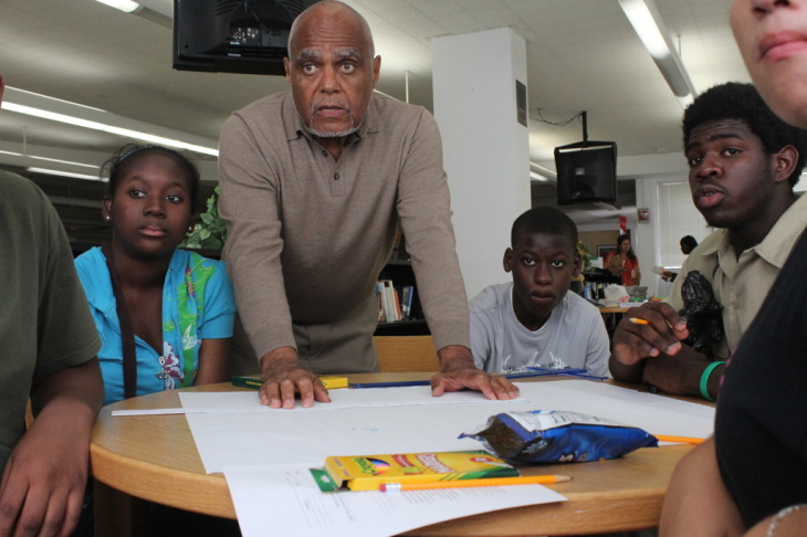 Bob Moses works with Jennifer Augustine, Guitoscard Denize, Darius Collins and other students who are part of this Algebra Project classroom. It's one of several student cohorts across the country where students who've struggled with math get to college-l