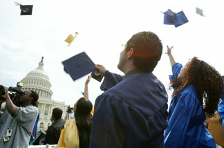 File photo: Students throw their caps during a mock graduation ceremony at the West Front of the U.S. Capitol April 20, 2004 in Washington, D.C.. Several hundred students and advocates took part in the ceremony and urged Congress and the Bush administration to pass the Dream Act, which would put U.S.-raised immigrant students on the path to college and U.S. citizenship.