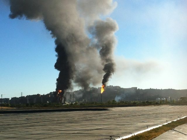 Black plumes of smoke erupt from a fire that is currently burning at a Chevron refinery near Richmond, CA.