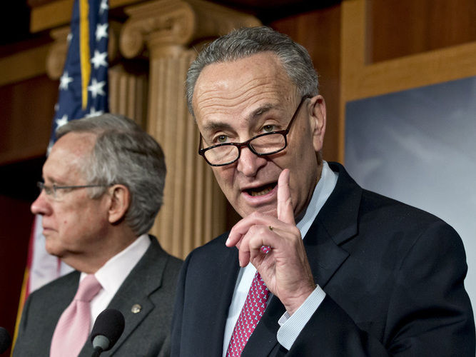 Sen. Charles Schumer, D-N.Y. (right), shown at a news conference Thursday on Capitol Hill with Senate Majority Leader Harry Reid, is arguing for raising taxes on the wealthy as part of a deal to avoid the fiscal cliff.