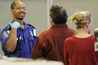 A TSA agent waits for approval to release travelers as they go through airport security at the screening area of the Richmond International airport in Richmond, Va., Tuesday, Nov. 23, 2010. The Obama administration's top transportation security official on Monday urged passengers angry over safety procedures not to boycott airport body scans.
