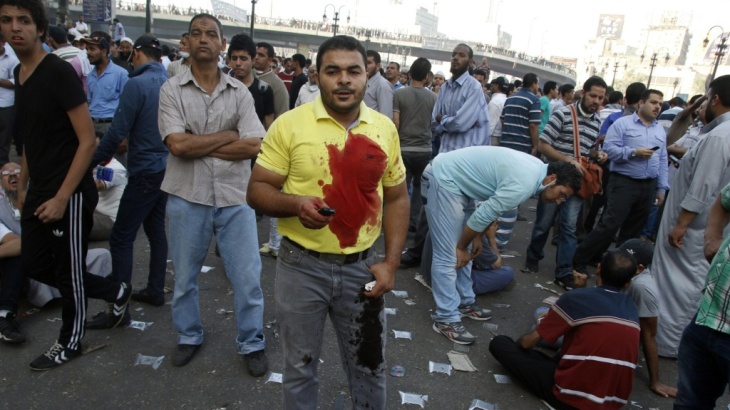 A pro-Morsi supporter stands with other demonstrators in Cairo's Abbassiya neighborhood on Friday.