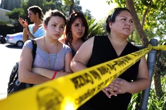 Family members wait for their children outside Gardena High School on Jan. 18, 2011 where two students were shot after a gun in another student's backpack accidentally discharged. From left to right are Eliut Maururi, Elisabeth Guerrero and Maria Avila.