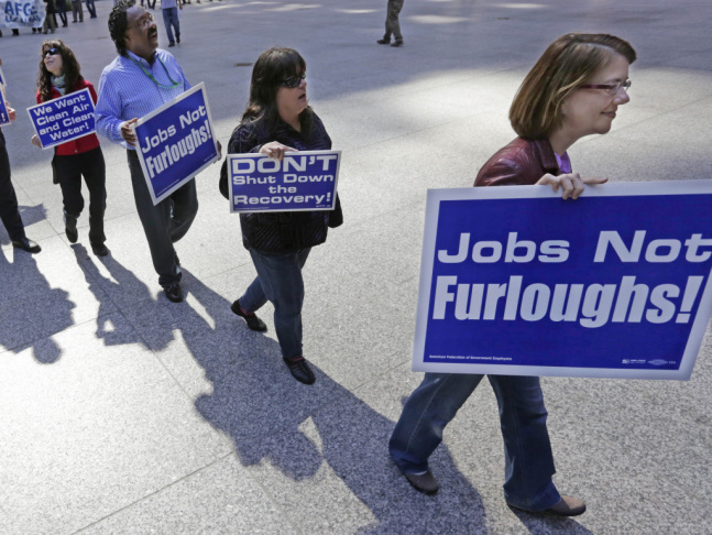 Government workers protest the possibility of a federal shutdown in Chicago. Nearly 100 employees from federal agencies including the Environmental Protection Agency and the Department of Housing and Urban Development rallied in a downtown plaza Monday.