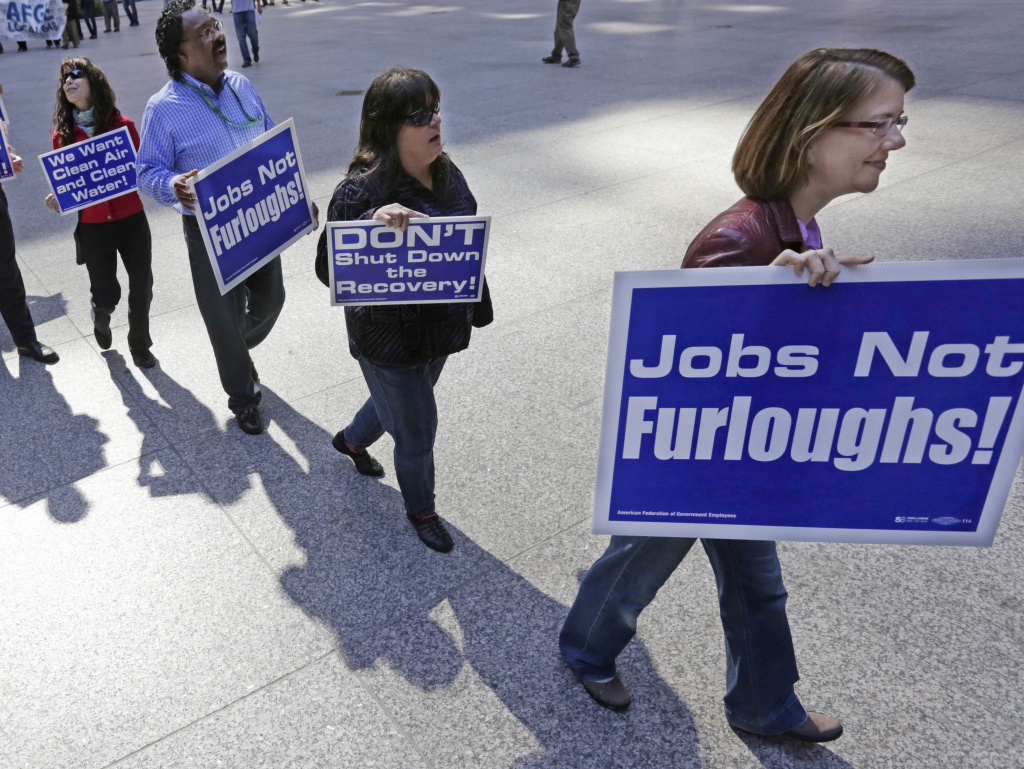 Government workers protest the possibility of a federal shutdown in Chicago. Nearly 100 employees from federal agencies including the Environmental Protection Agency and the Department of Housing and Urban Development rallied in a downtown plaza Monday.