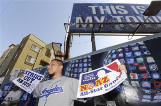 John Morales protests Arizona's crackdown on illegal immigration, outside Dodger Stadium before the Los Angeles Dodgers' baseball series with the Arizona Diamondbacks, Monday, May 31, 2010, in Los Angeles.