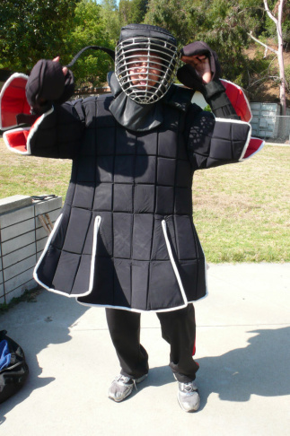 An eskrima martial artist dons his protective sparring gear