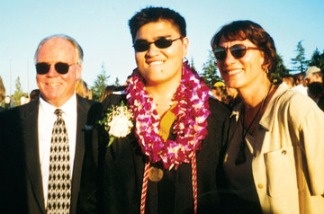 Jose Antonio Vargas (center) poses at his high school graduation with school officials Rich Fischer and Pat Hyland (right). The Pulitzer-winning journalist learned at age 16 that he was in the United States illegally.