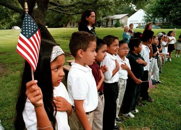 Latino elementary school students recite the Pledge of Allegiance during a September 11 memorial service in Tyler, Texas, 2003