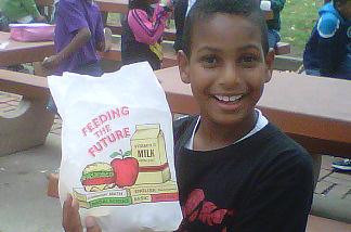 Cade Moore, 9, of Los Angeles, enjoys his free lunch at Ladera Park, in L.A.
