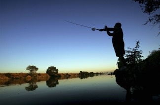 A fisherman casts his line into the Sacramento River in the Sacramento-San Joaquin River Delta south of Sacramento.