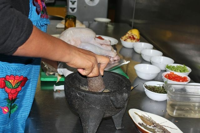 Maria de Jesus Lopez, co-owner of of the Guelaguetza restaurant in Los Angeles' Koreatown, grinds spices to prepare one her Oaxacan-style turkeys for a Thanksgiving dinner order. November 20, 2012