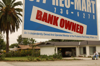 File photo: A realtor sign advertises a bank-owned house for sale June 15, 2009 in Pasadena.