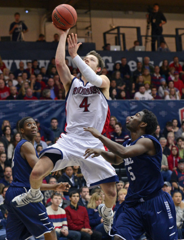 St. Mary's' Matthew Dellavedova goes up for a basket against Yale Bulldogs' Justin Sears and Michael Grace.