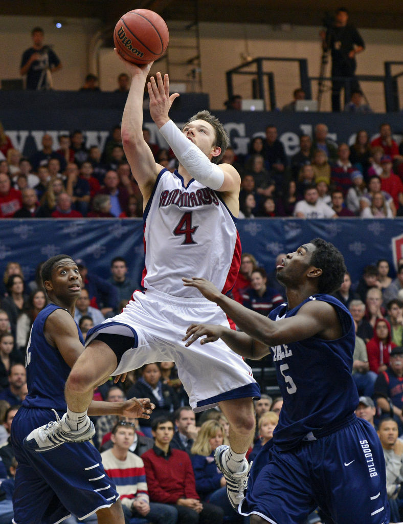 St. Mary's' Matthew Dellavedova goes up for a basket against Yale Bulldogs' Justin Sears and Michael Grace.