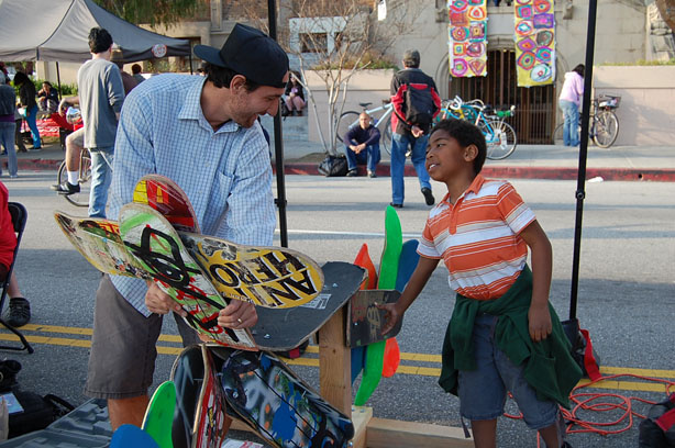 Jack Martinez, who is with the Los Angeles Arts and Athletics Alliance, builds a sculpture made of old skateboards.