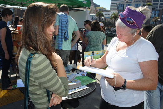 Shopper signs petition at farmer's market