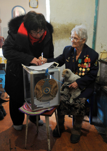 A woman prepares to cast her vote in a m