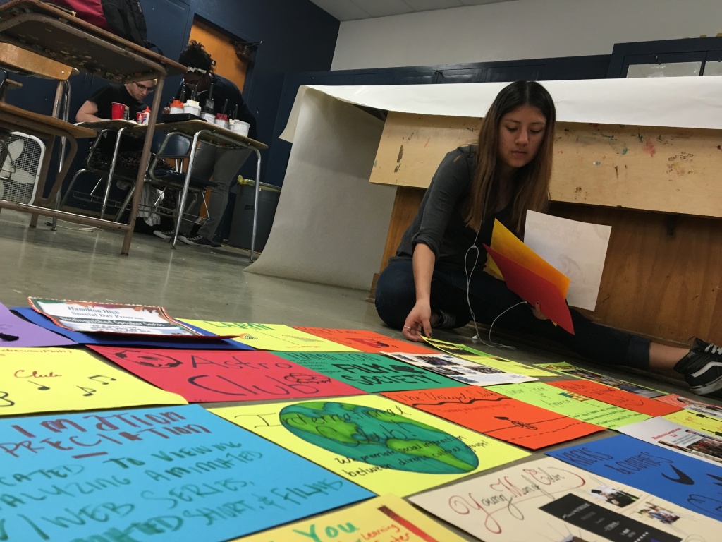 A member of the student government at Hamilton High School in West Los Angeles helps assemble a "quilt," comprised of roughly 100 cardstock panels representing the school's clubs and academic programs, on Friday, Feb. 12, 2016. The quilt will be displayed at a rally at the school on Wednesday, Feb. 17.