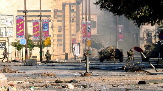 Government forces patrol a district under their control in Aleppo, Syria, on Friday.