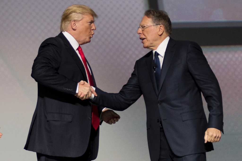US-POLITICS-TRUMP-NRA U.S. President Donald Trump shakes hands with National Rifle Association (NRA) President Wayne LaPierre during the NRA Leadership Forum in Atlanta, Georgia on April 28, 2017.