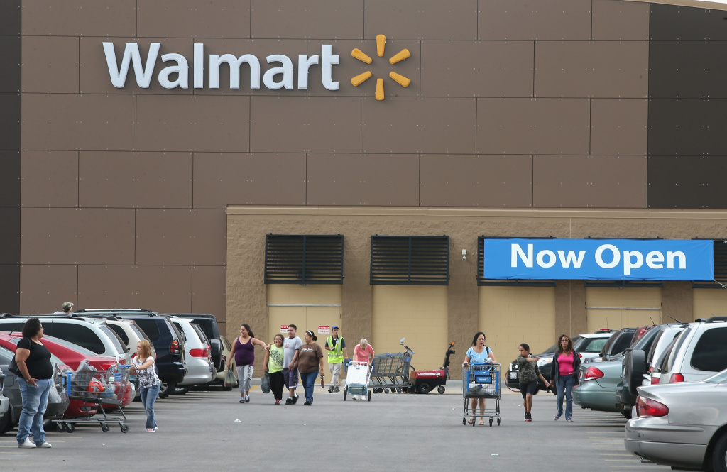 Wal-Mart Lowers Earnings Estimate After Weak Second Quarter Customers shop at a Walmart store on August 15, 2013 in Chicago, Illinois.