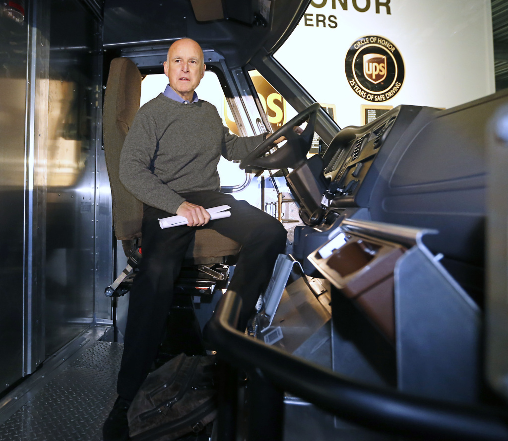 Gov. Jerry Brown sits in the driver's seat of a electric-powered UPS delivery truck at the UPS distribution center in West Sacramento, Calif., in February. Brown was one of eight governors scheduled to gather in Sacramento on Thursday, Oct. 24, 2013, to sign a memorandum of understanding that would get 3.3 million zero-emission vehicles on roadways by 2025.