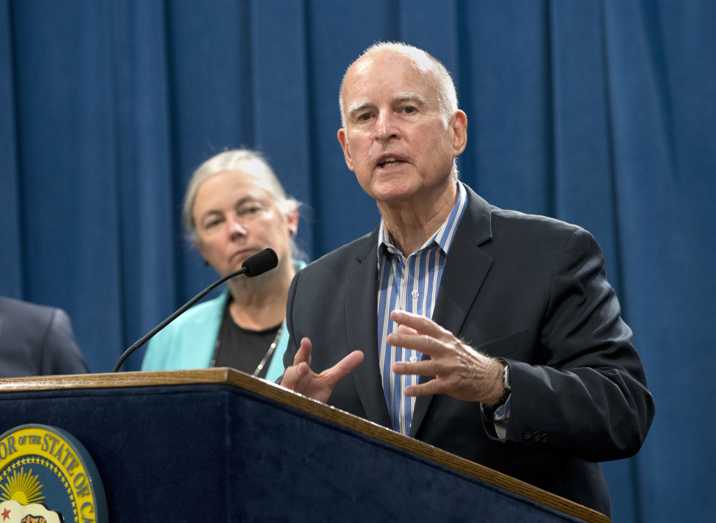 Climate Change California Calif. Gov. Jerry Brown discusses the passage of a measure for a 10-year extension of the state's landmark climate change law during a news conference, Wednesday, Aug. 24, 2016, in Sacramento, Calif. Brown said he would sign SB32, by Sen Fran Pavley, D-Agoura Hills, left, that sets a new goal to reduce greenhouse gas emissions to 40 percent below 1990 levels by 2030.