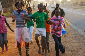 Children of Mamelodi Township celebrate during halftime after South Africa scored two goals in the first half against France during the 2010 World Cup match on June 22, 2010 east of Pretoria, South Africa.