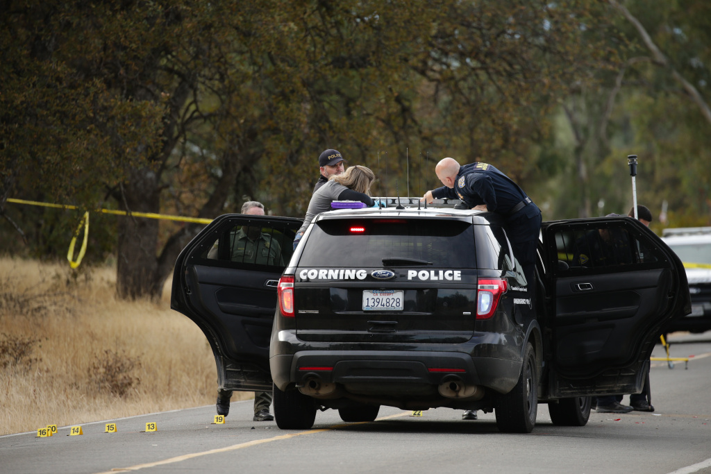 US-crime-shooting Law enforcement officers stand near one of many crime scenes after a shooting on November 14, 2017, in Rancho Tehama, California. Four people were killed and nearly a dozen were wounded when a gunman went on a rampage at multiple locations.