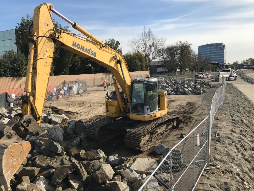 Homeless encampment Orange County An earthmover pushes boulders to cover an area previously occupied by several homeless people.