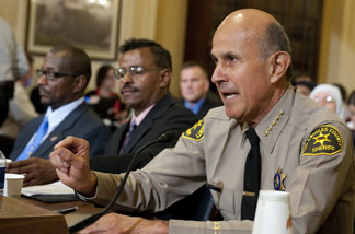 Leroy Baca (R), Sheriff of Los Angeles County, Melvin Bledsoe (L), and Abdirizak Bihi (C), director of the Somali Education and Social Advocacy Center testify before the Committee on Homeland Security holds the first in a series of hearings on radicalization in the American Muslim community, on Capitol Hill in Washington, DC, March 10, 2011.