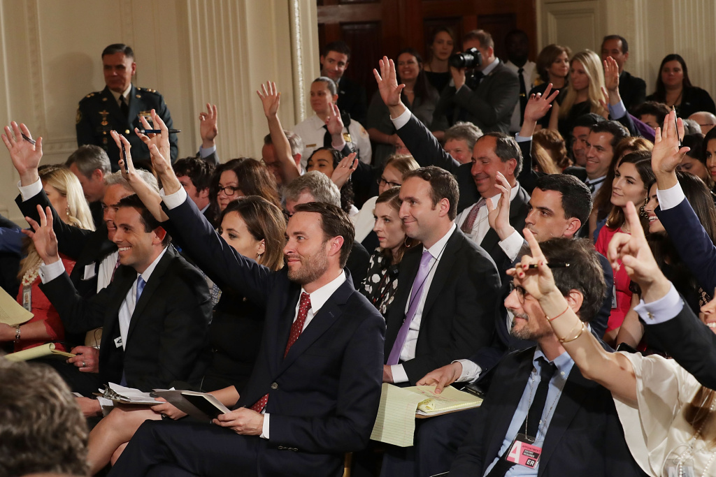 Donald Trump Holds Joint Press Conference With Colombian President Santos WASHINGTON, DC - MAY 18: Reporters raise their hands to ask questions during a news conference with Colombian President Juan Manuel Santos and U.S. President Donald Trump in the East Room of the White House May 18, 2017 in Washington, DC. The Trump administration has said it wants to slash foreign aide and Santos will most likely seek a renewal of $450 million dollars from the U.S. that supports the peace accord between the Columbian government at the Revolutionary Armed Forces (FARC). (Photo by Chip Somodevilla/Getty Images)