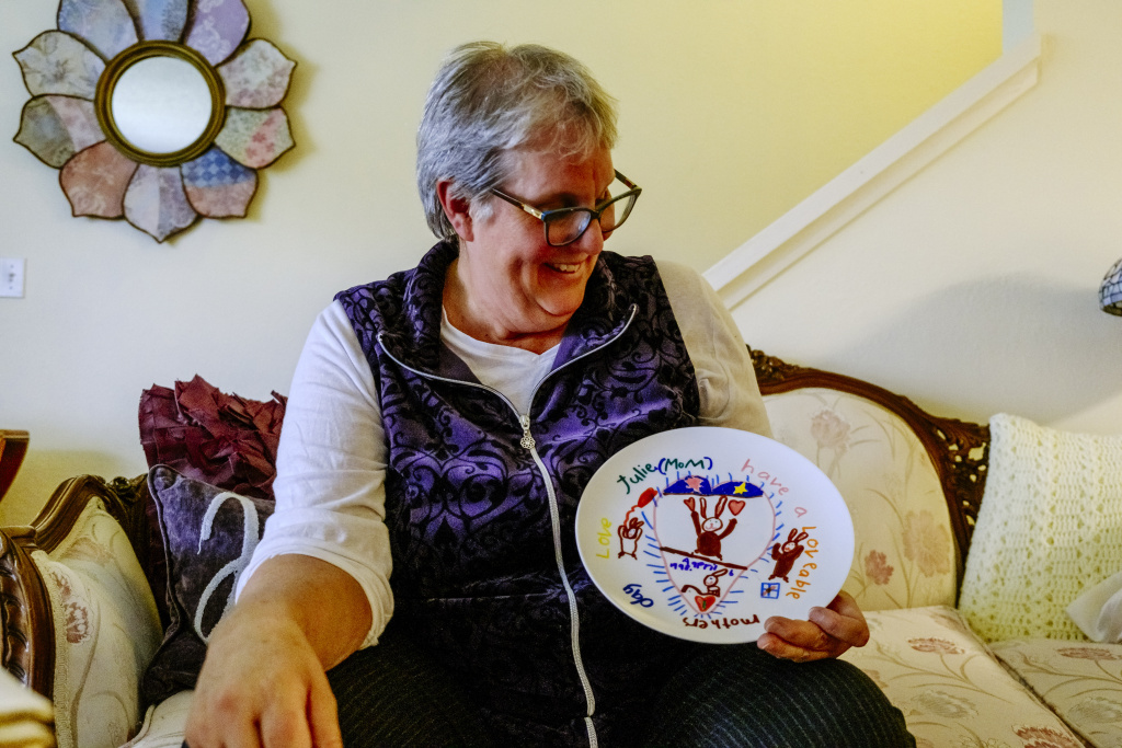 Audrey Woolfolk at Home Audrey Woolfolk holds a plate that Julie decorated for a Mother's Day gift when she was younger.