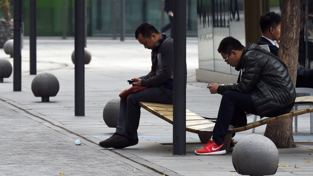 An international tariff on high-tech goods could be rewritten, thanks to negotiations in China. Here, men use smartphones in Beijing last month, days after Apple released its iPhone 6 in the Chinese market. An international tariff on high-tech goods could be rewritten, thanks to negotiations in China. Here, men use smartphones in Beijing last month, days after Apple released its iPhone 6 in the Chinese market.