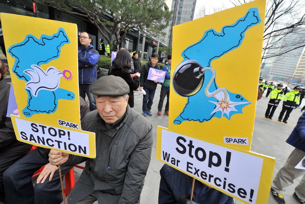 SKOREA-US-NKOREA-MILITARY Anti-war activists hold placards showing the Korean Peninsula during a protest against a joint military exercise between South Korea and the US, called Key Resolve, near the US embassy in Seoul on March 12, 2013. North Korea leader Kim Jong-Un threatened to 'wipe out' a South Korean island as Pyongyang came under new economic and diplomatic fire on March 12, from US sanctions and UN charges of gross rights abuses.