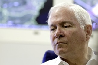 U.S. Defense Secretary Robert Gates pauses to listen to a question as he talks with media aboard a U.S. Military Aircraft October 13, 2010 en route from Hanoi, Vietnam to Brussels, Belgium. Gates said today that the courts should not decide on the military's 'don't ask, don't tell' policy, in response to a judge in California ordering the Pentagon to stop enforcing its policy of barring gays from openly serving.