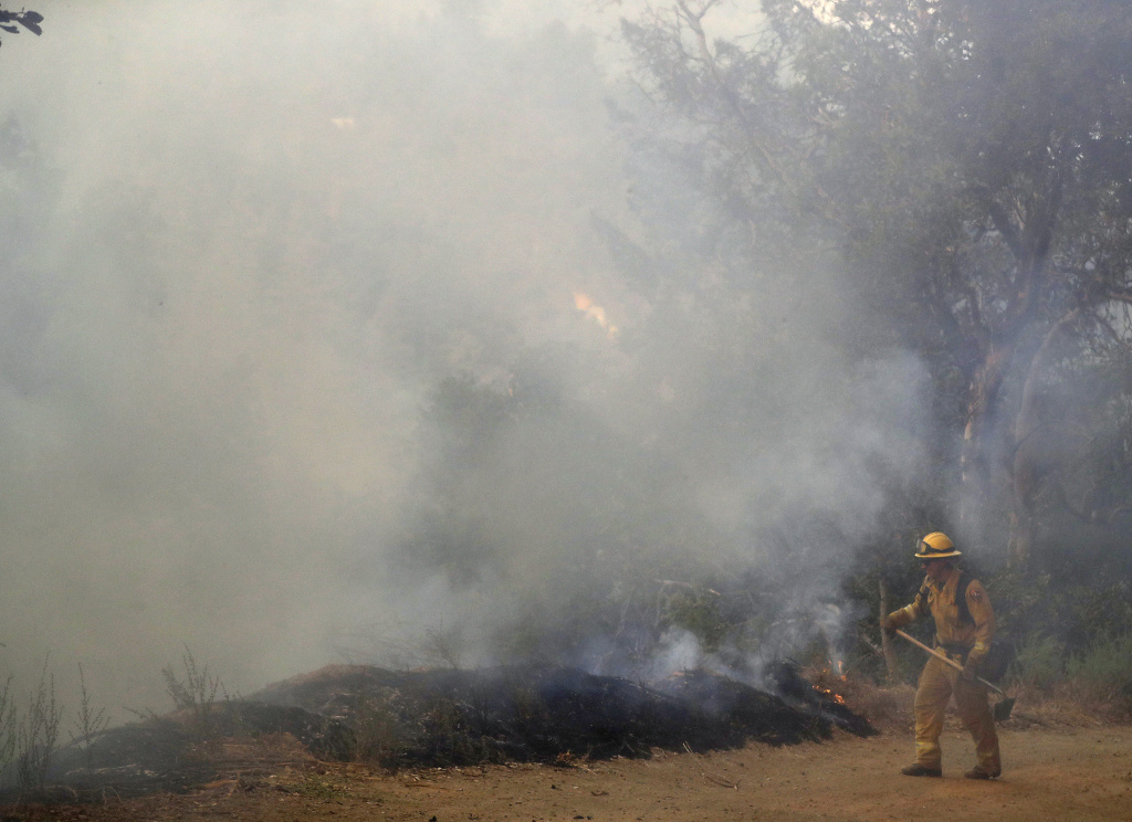 California Wildfires A firefighter monitors a wildfire near Boulder Creek in the Santa Cruz mountains of Northern California in this Oct. 17, 2017 photo.