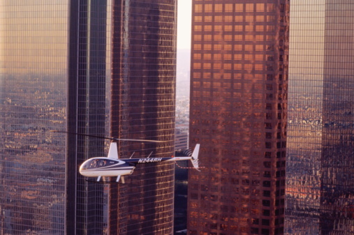A Robinson R44 helicopter in flight over Los Angeles, CA
