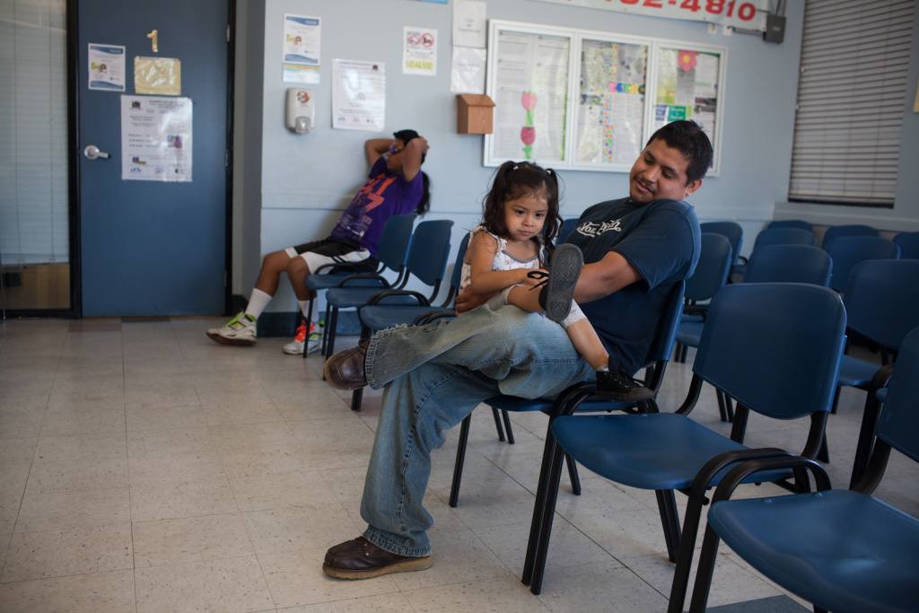 Healthcare Stock Alondra Manzanarez and her father David wait for care at the South Central Family Health Center. They do not have insurance and have been coming to the center for three years.