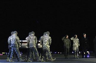 An Army carry team carries the transfer case containing the remains of Army Cpl. Kenneth E. Necochea Jr. of San Diego Calif., as Vice Chairman of the Joint Chief of Staff Gen. James E. Cartwright, left, and Lt. Gen. William J. Troy, second from left, salute at Dover Air Force Base, Del. Necochea was among six American soldiers from the 101st Airborne Division based at Fort Campbell, Ky. who were killed in a Sunday, Dec. 12, 2010 suicide bomb attack in Afghanistan. The 101st Airborne Division, a force in America's major conflicts since World War II, is seeing its worst casualties in a decade as the 2010 U.S. surge in Afghanistan turns into the deadliest year in that war for the NATO coalition.