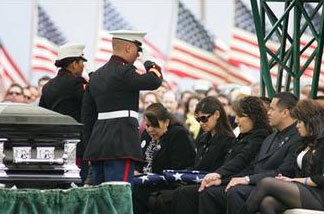 In this March 8, 2010 file photo, Marines salute Saloma Bejar and Mariam Bejar, the mother and wife of fallen officer Javier Bejar, after presenting the ceremonial flag at cemetery services in Reedley, Calif.