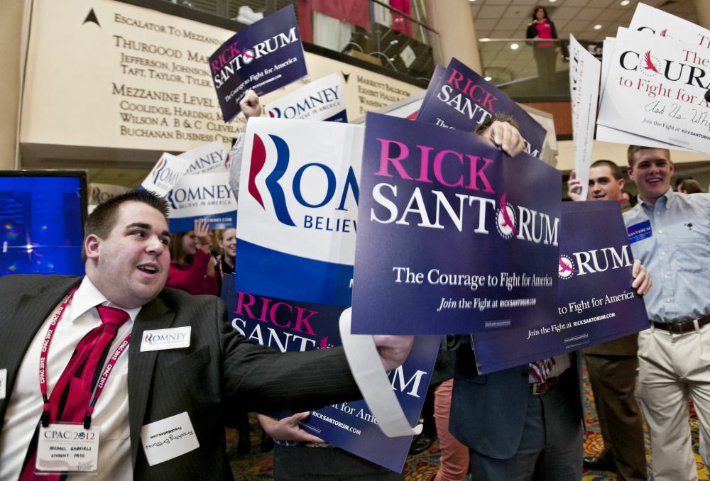 Supporters of Rick Santorum and Mitt Romney vie for attention, Feb. 11, 2012. Next Tuesday, Arizona will hold its primary and the winner will take all of the state's delegates. Supporters of Rick Santorum and Mitt Romney vie for attention, Feb. 11, 2012. Next Tuesday, Arizona will hold its primary and the winner will take all of the state's delegates.
