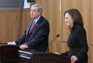 San Francisco District Attorney, Kamala Harris, right, the Democratic candidate for Attorney General, laughs at a light-hearted comment made by her opponent, Los Angeles County District Attorney Steve Cooley, left, during their debate at the University of California, Davis, School of Law in Davis, Calif., Tuesday, Oct. 5, 2010.