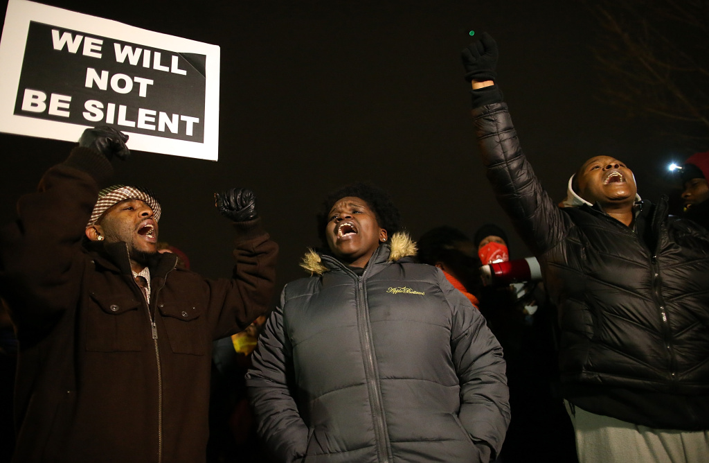 Grand Jury Decision Reached In Ferguson Shooting Case FERGUSON, MO - NOVEMBER 24: Demonstrators block traffic as they protest in front of the Ferguson police department on November 24, 2014 in Ferguson, Missouri. A St. Louis County grand jury has decided to not indict Ferguson police Officer Darren Wilson in the shooting of Michael Brown that sparked riots in Ferguson, Missouri in August. (Photo by Justin Sullivan/Getty Images)