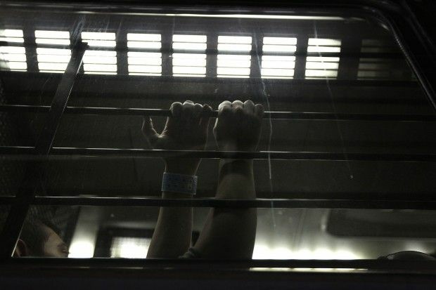 A detainee waits to be processed at an immigrant detention facility Arizona. Photo by John Moore/Getty Images